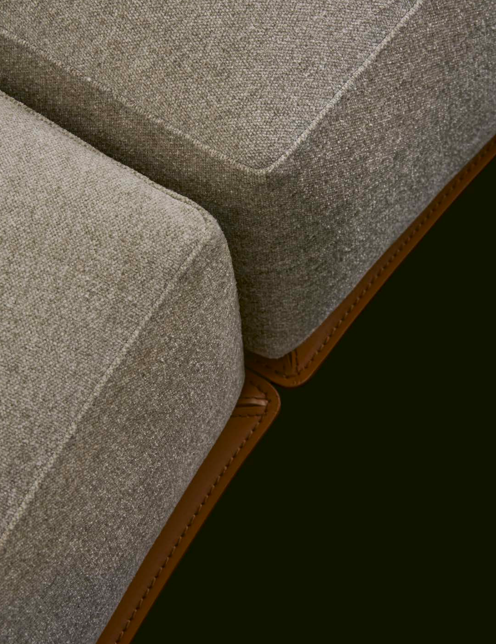 Sculptural Curved Sofa with Leather-Wrapped Base and Contrast Stitch Detailing