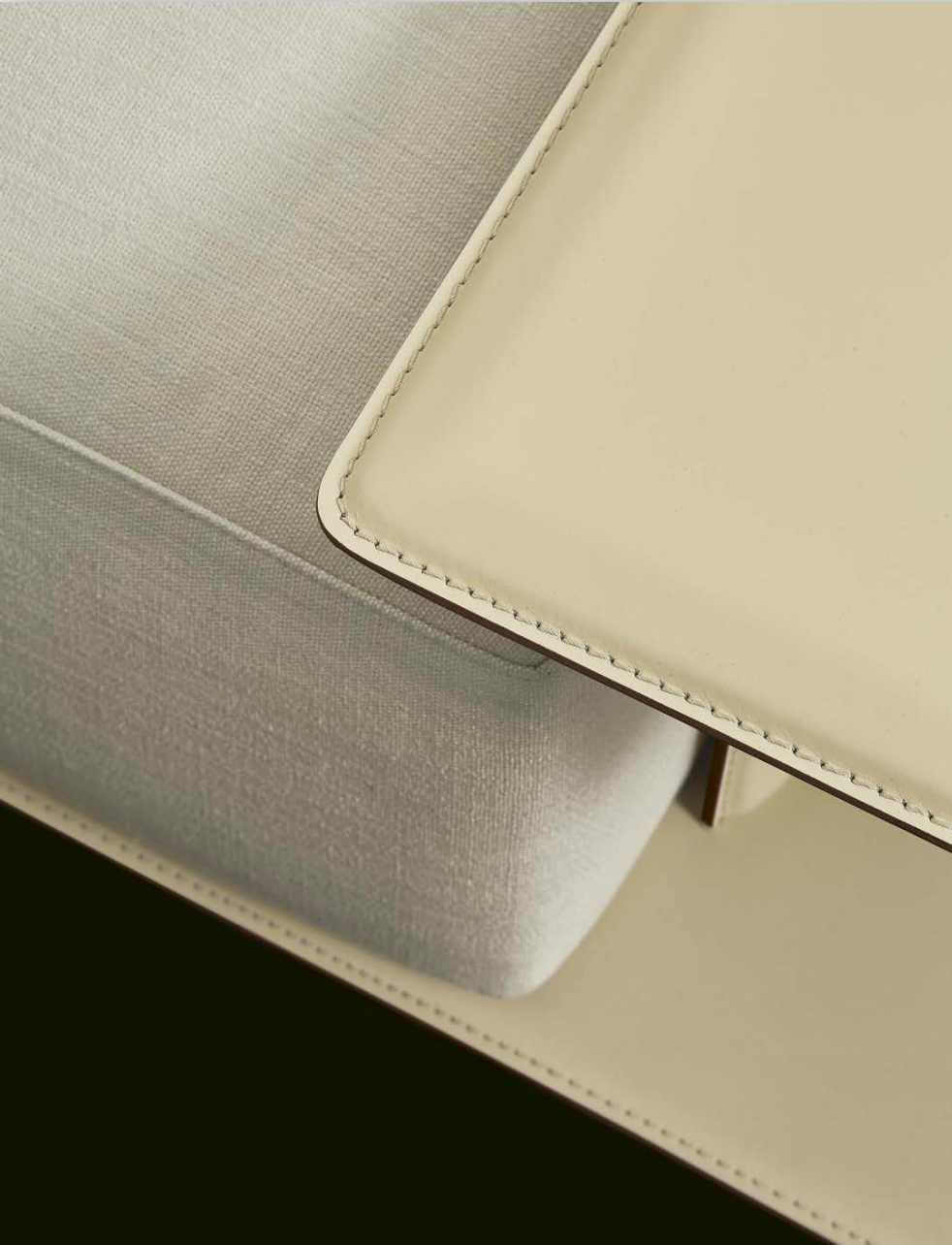 Sculptural Curved Sofa with Leather-Wrapped Base and Contrast Stitch Detailing