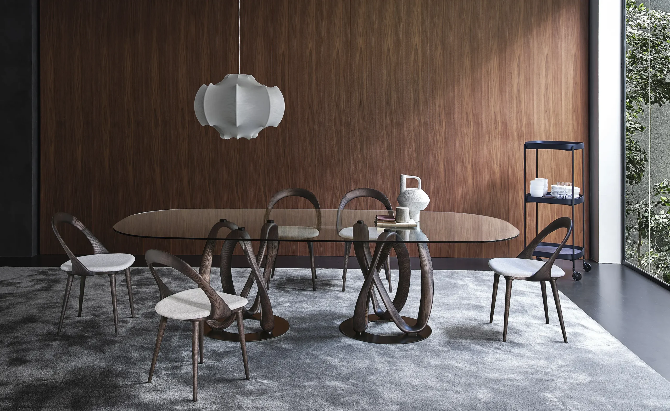 Round Glass Dining Table with Intertwined Wood Legs and Chrome Base